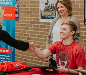 Grant accepts his facilities scholarship from C&W Services to attend trade school.