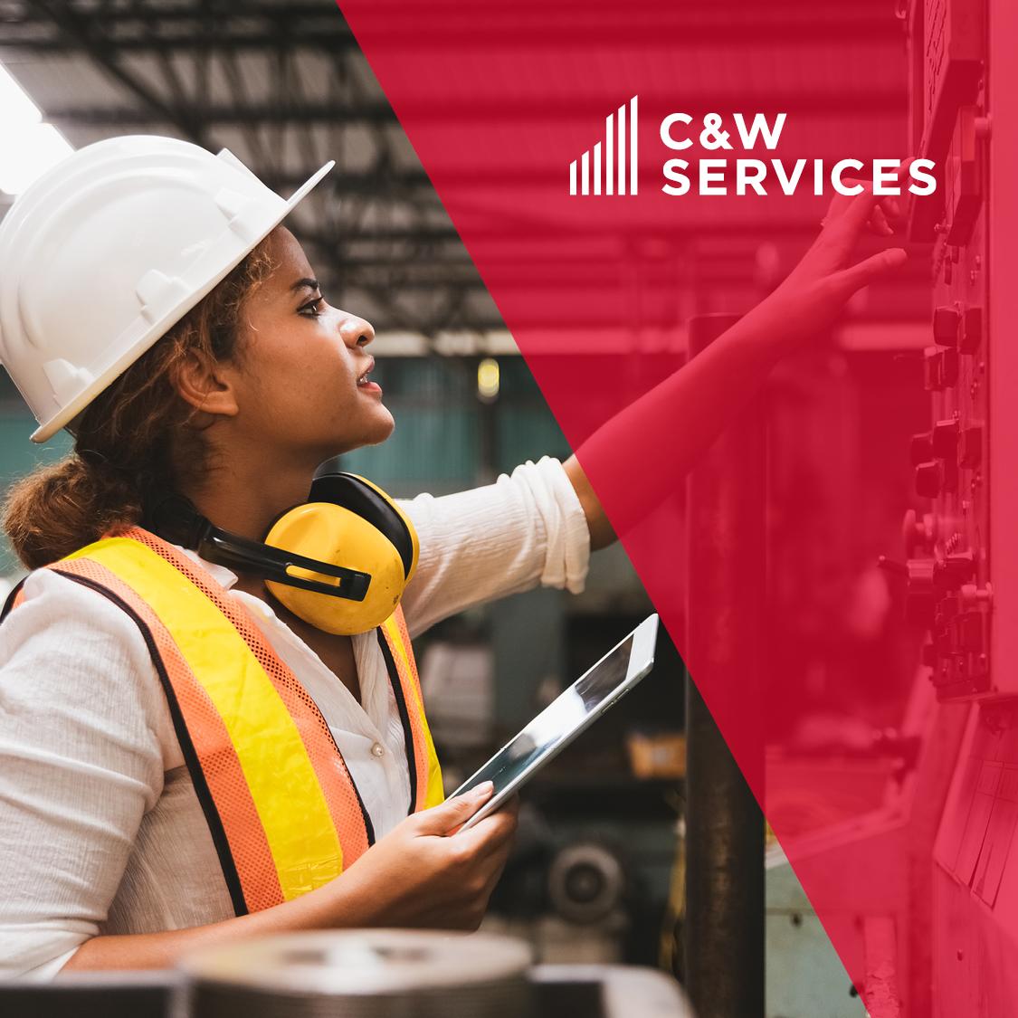 A woman wearing a hard hat and hard hat with the words caw services.