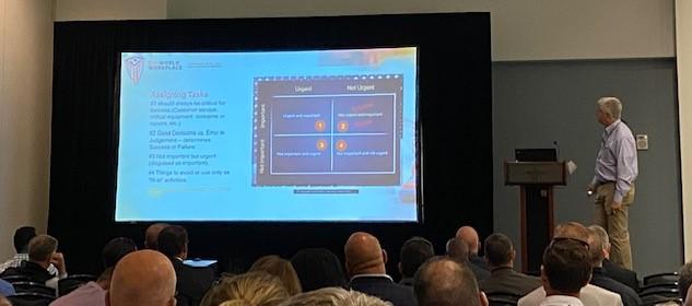 A man giving a presentation at a conference.