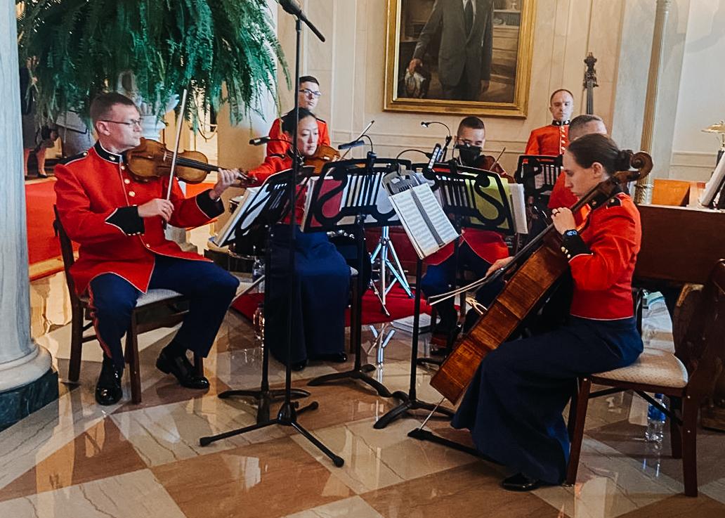 A group of musicians playing instruments in a room.