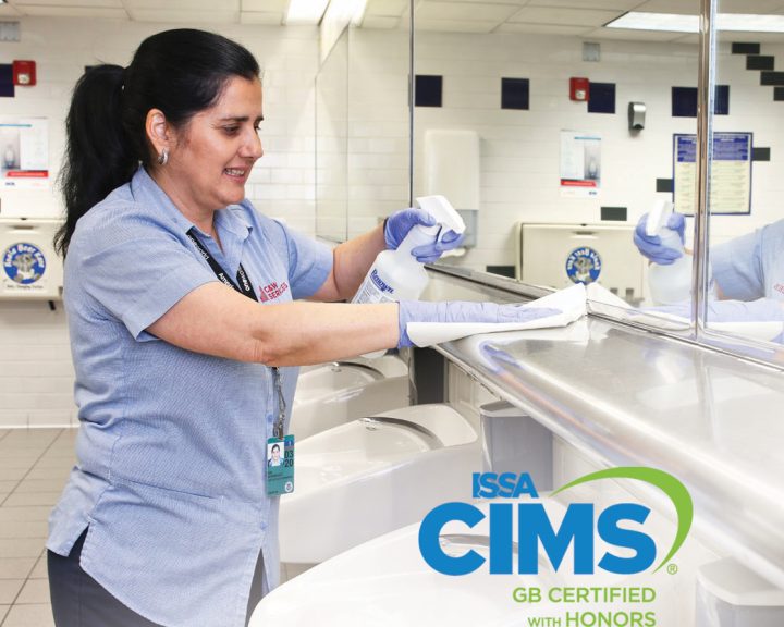 A woman cleaning a bathroom sink.