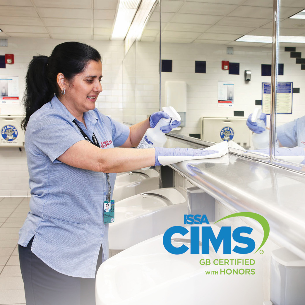 A woman cleaning a bathroom sink.