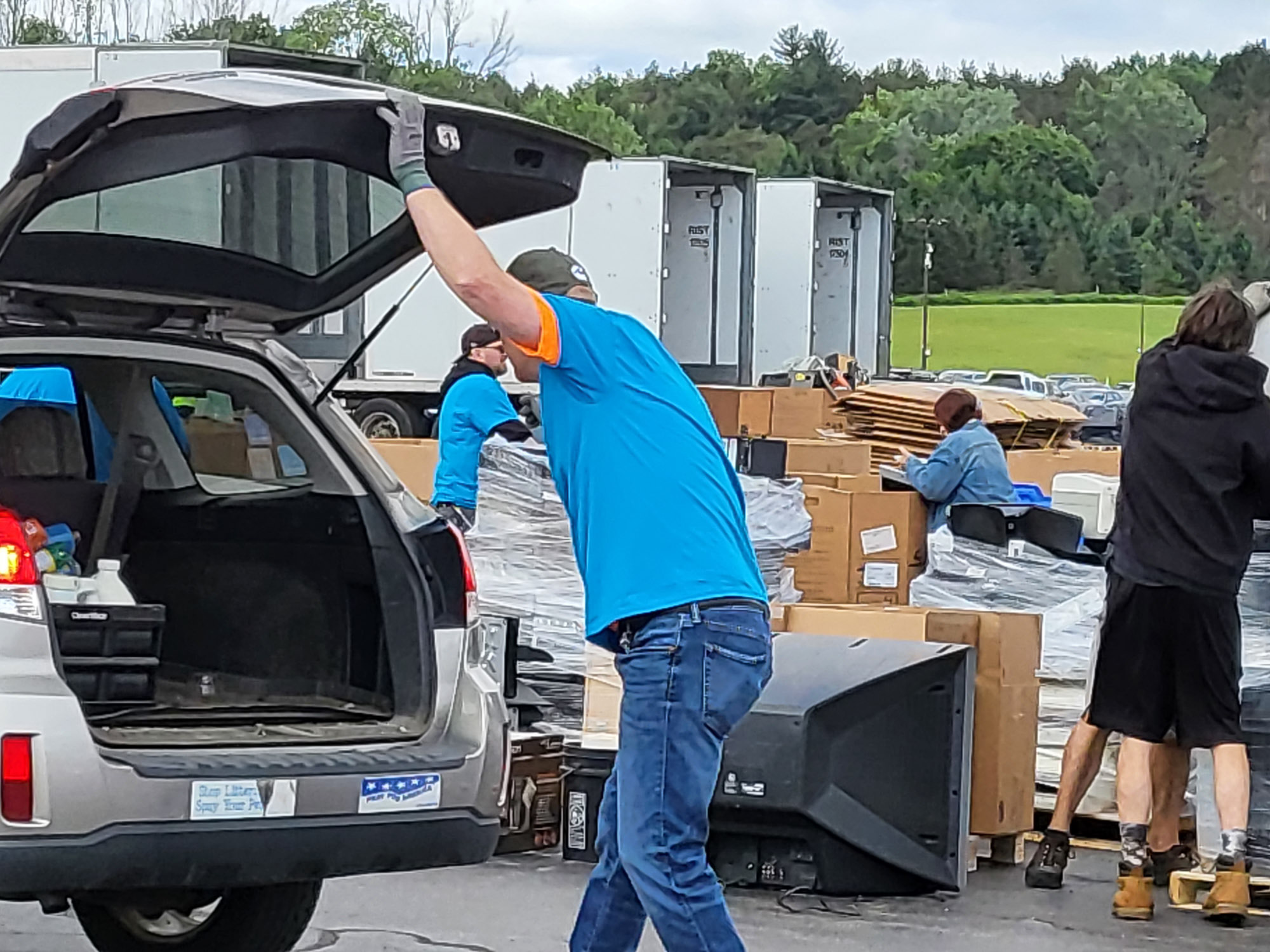 A man loading boxes into a car.