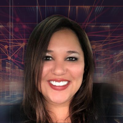 A woman smiling in front of an abstract background.
