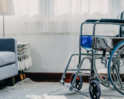 Empty wheelchair parked in assisted living room